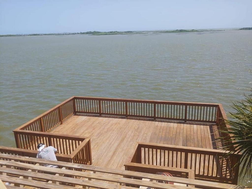 A wooden deck overlooking a body of water