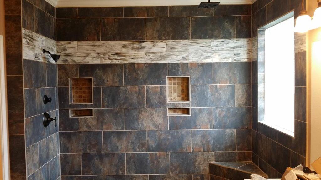 A bathroom with a walk in shower and a window