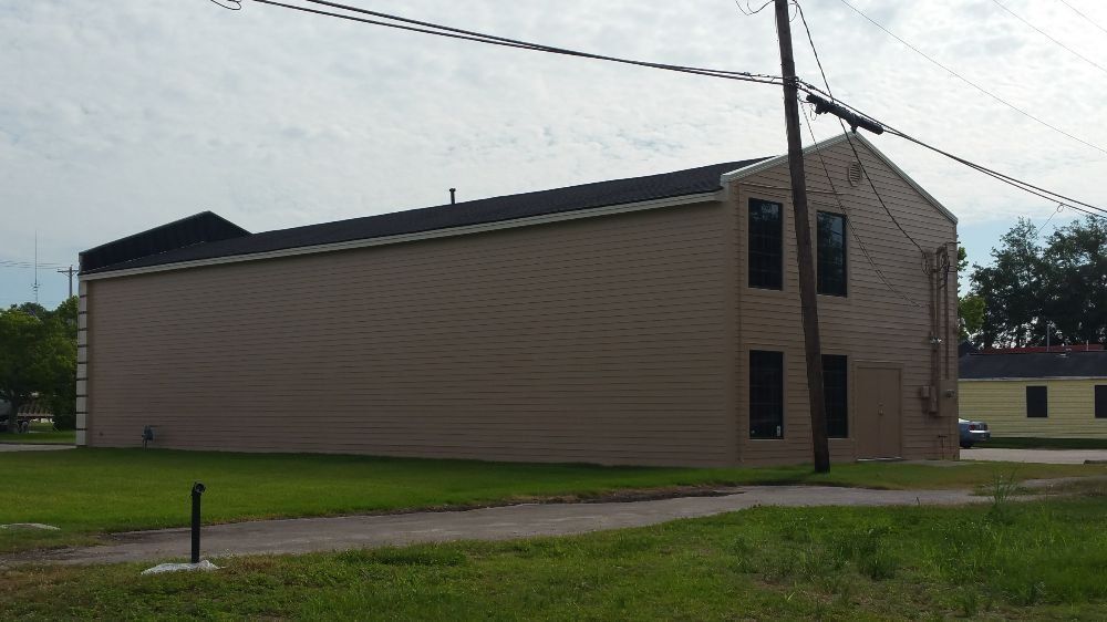 A large building with a telephone pole in front of it
