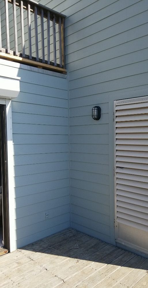 There is a light on the side of the building.