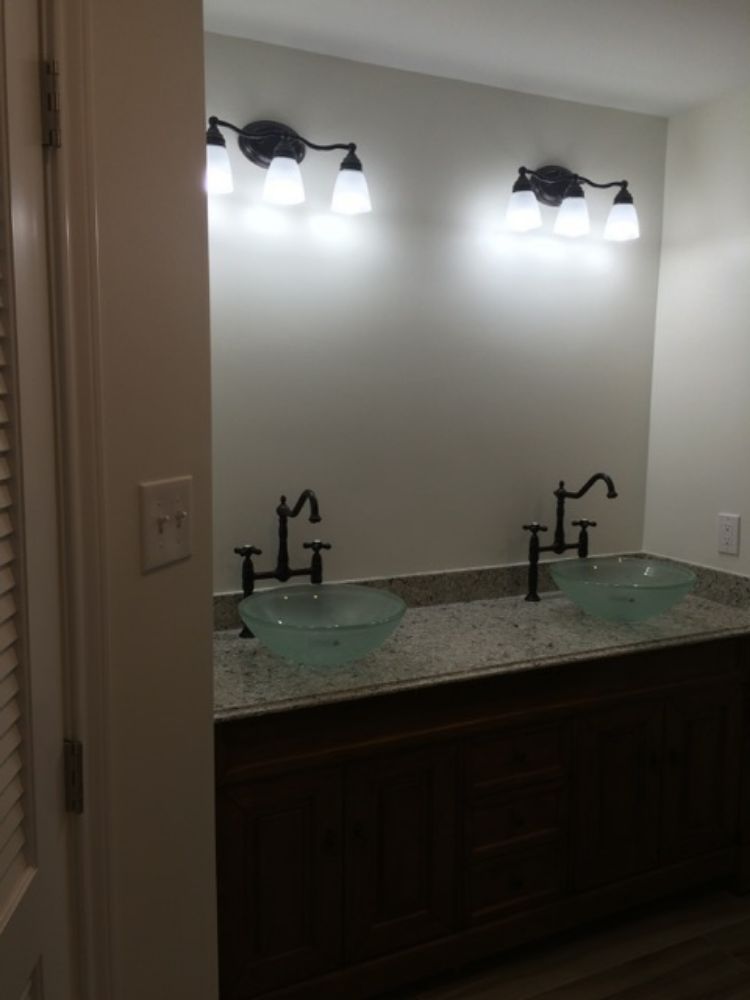 A bathroom with two sinks and a mirror