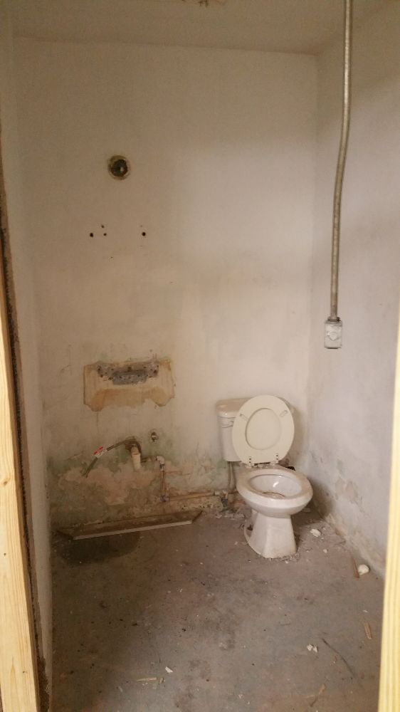 An empty bathroom with a toilet and a sink.