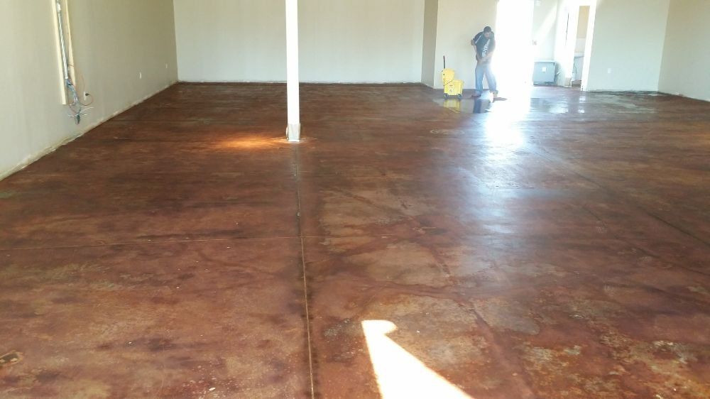 A man is standing on a concrete floor in a room.