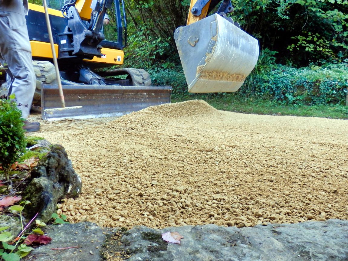 A man is using a bulldozer to dig a hole in the ground