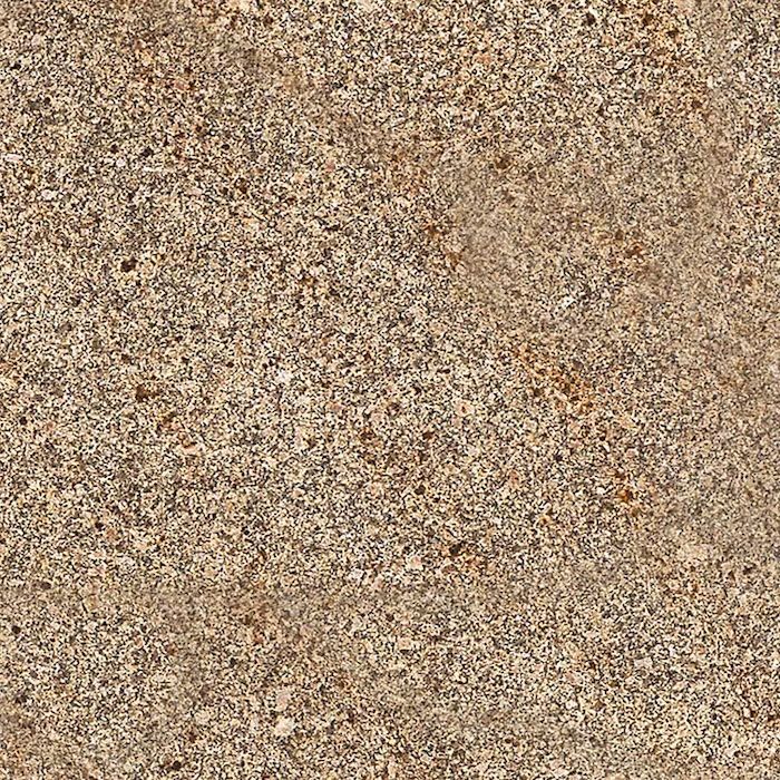Un primer plano de una superficie arenosa con textura granulada.