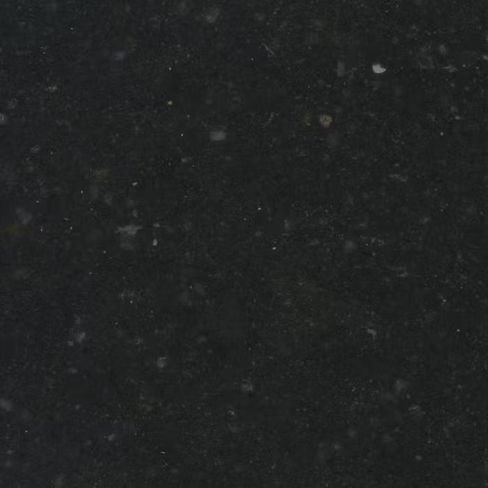 Un primer plano de una superficie negra con manchas blancas.