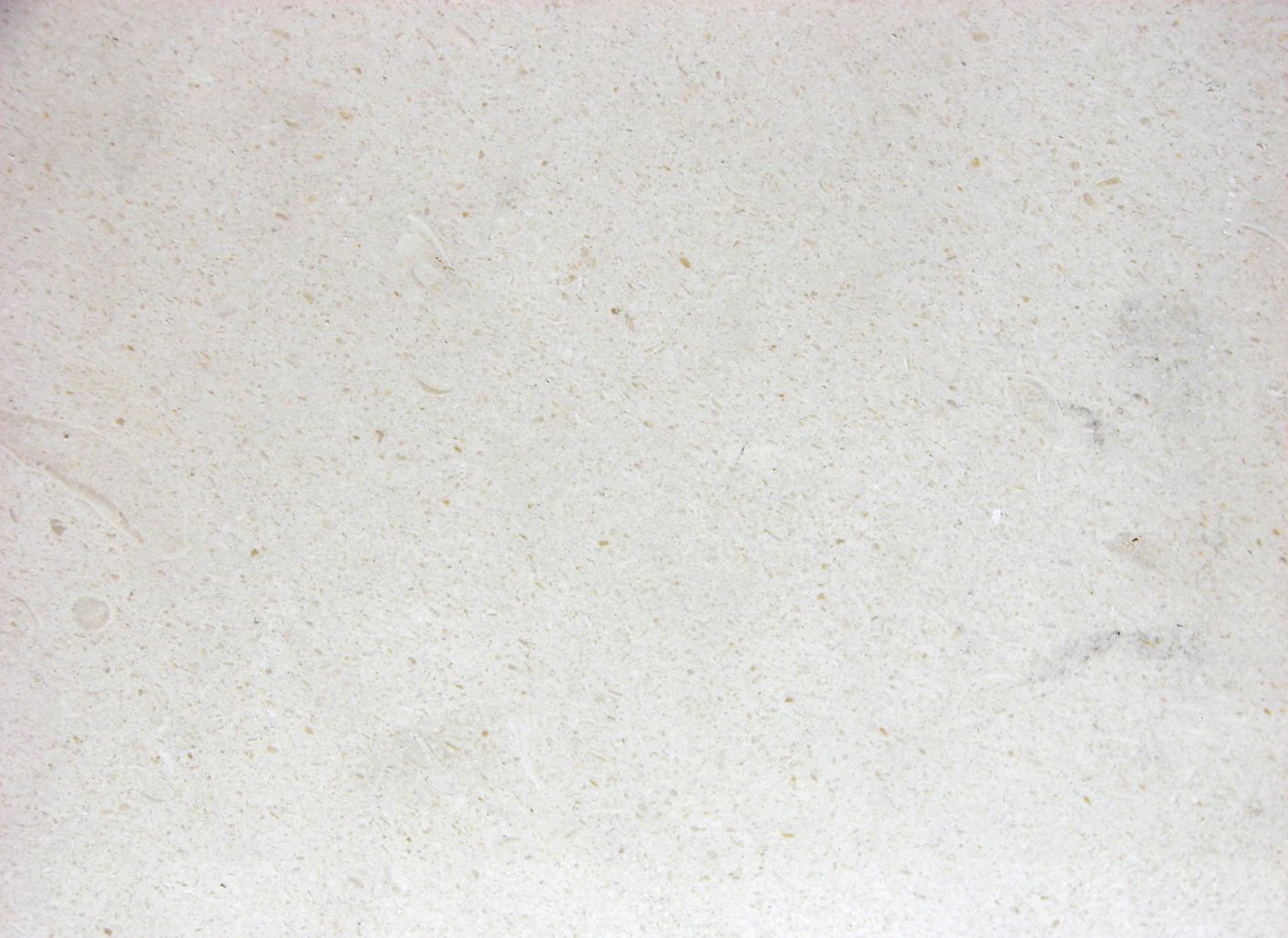 Un primer plano de una superficie blanca con una textura granulada.