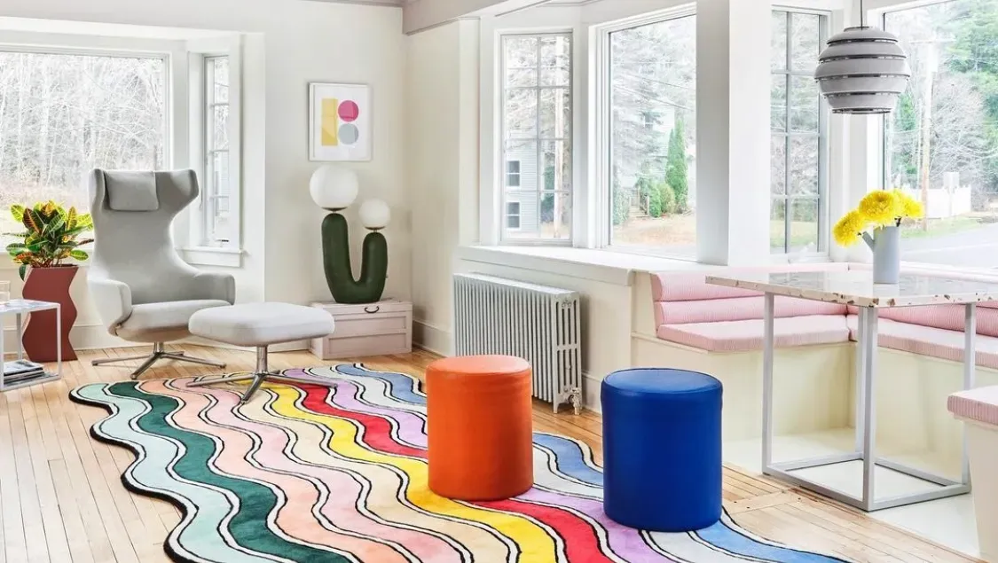 Un salón lleno de muebles y una alfombra de colores.