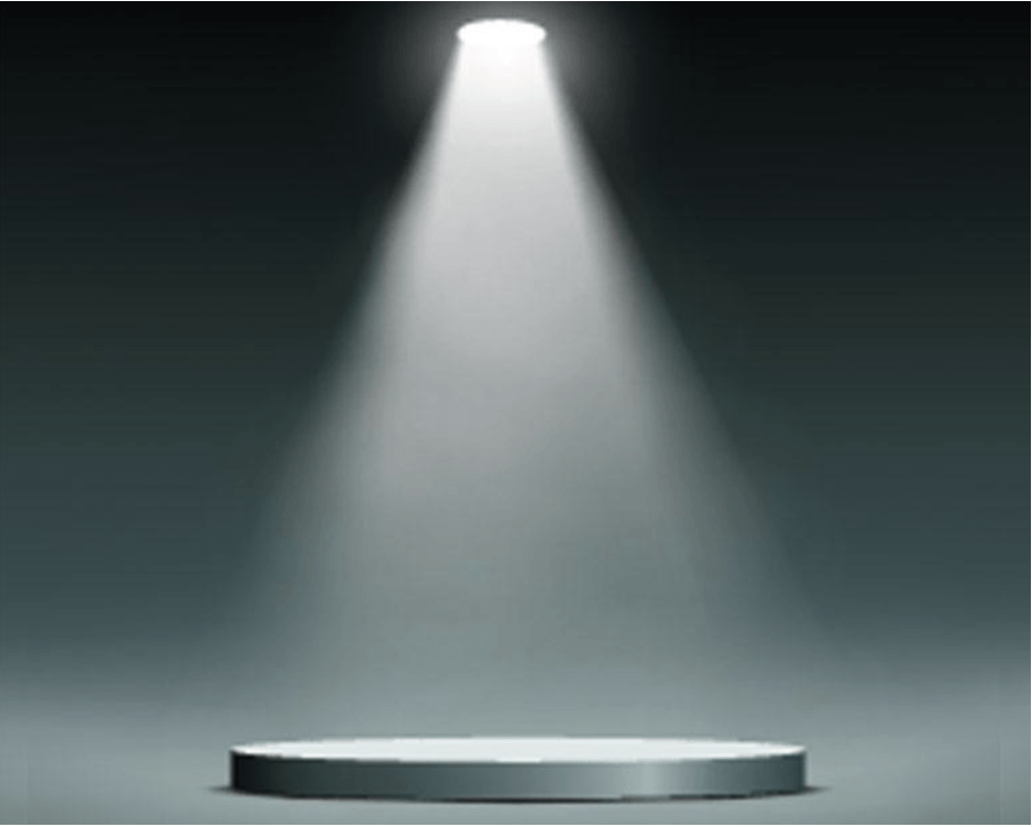 Un podio está iluminado por un foco en una habitación oscura.