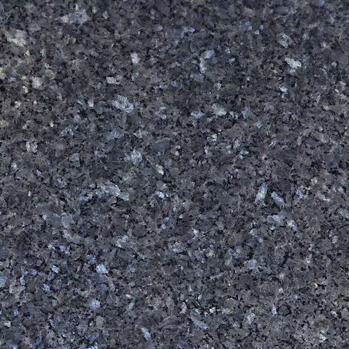 Un primer plano de una encimera de granito negro con manchas blancas.