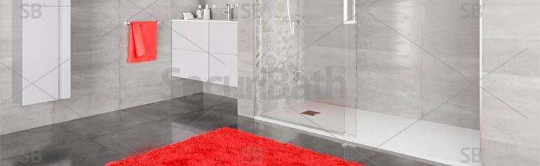 Un baño con alfombra roja y cabina de ducha.
