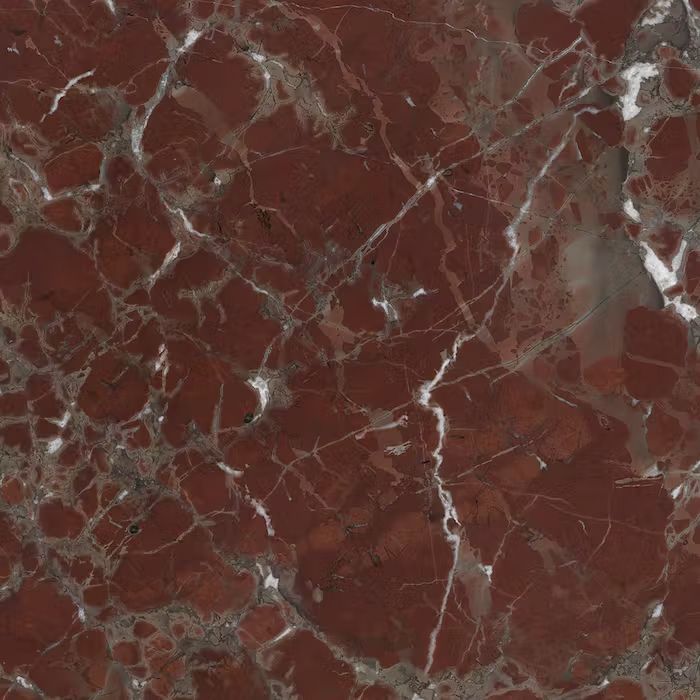Un primer plano de una textura de mármol rojo con vetas blancas