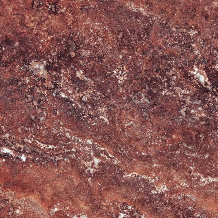 Un primer plano de una roca marrón con manchas blancas