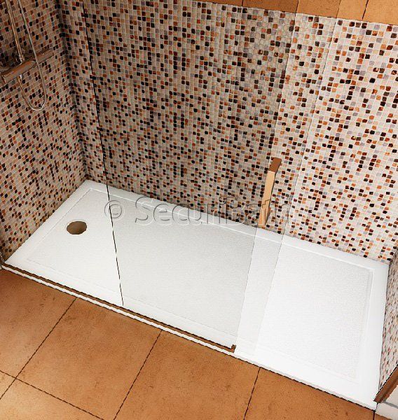 Un baño con plato de ducha y pared de azulejos.
