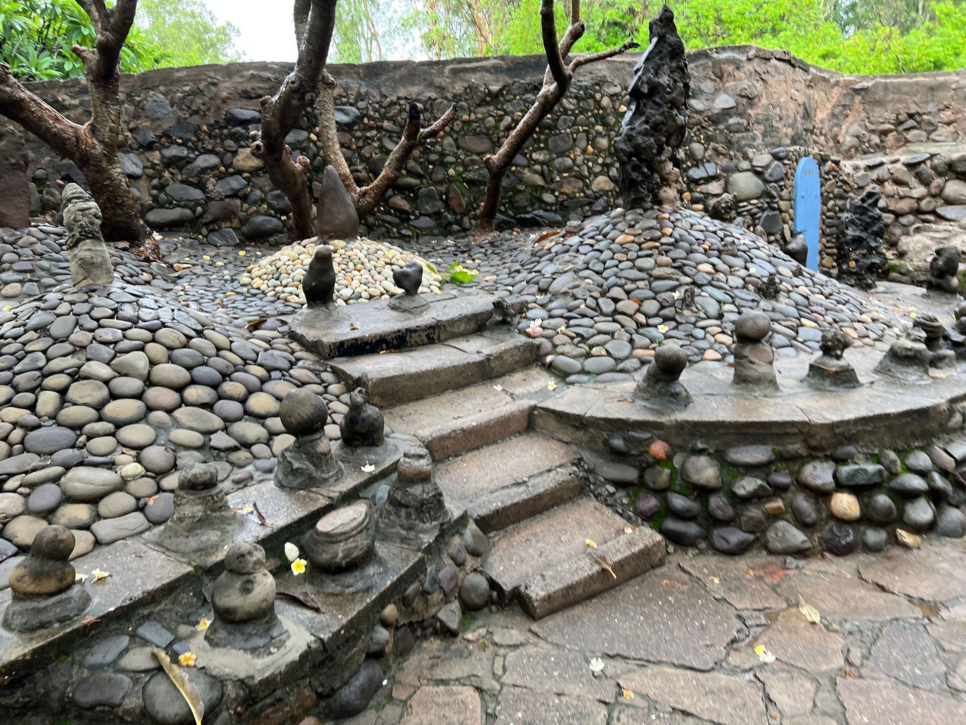 Stone steps and pathways in a rock garden with sculptures.