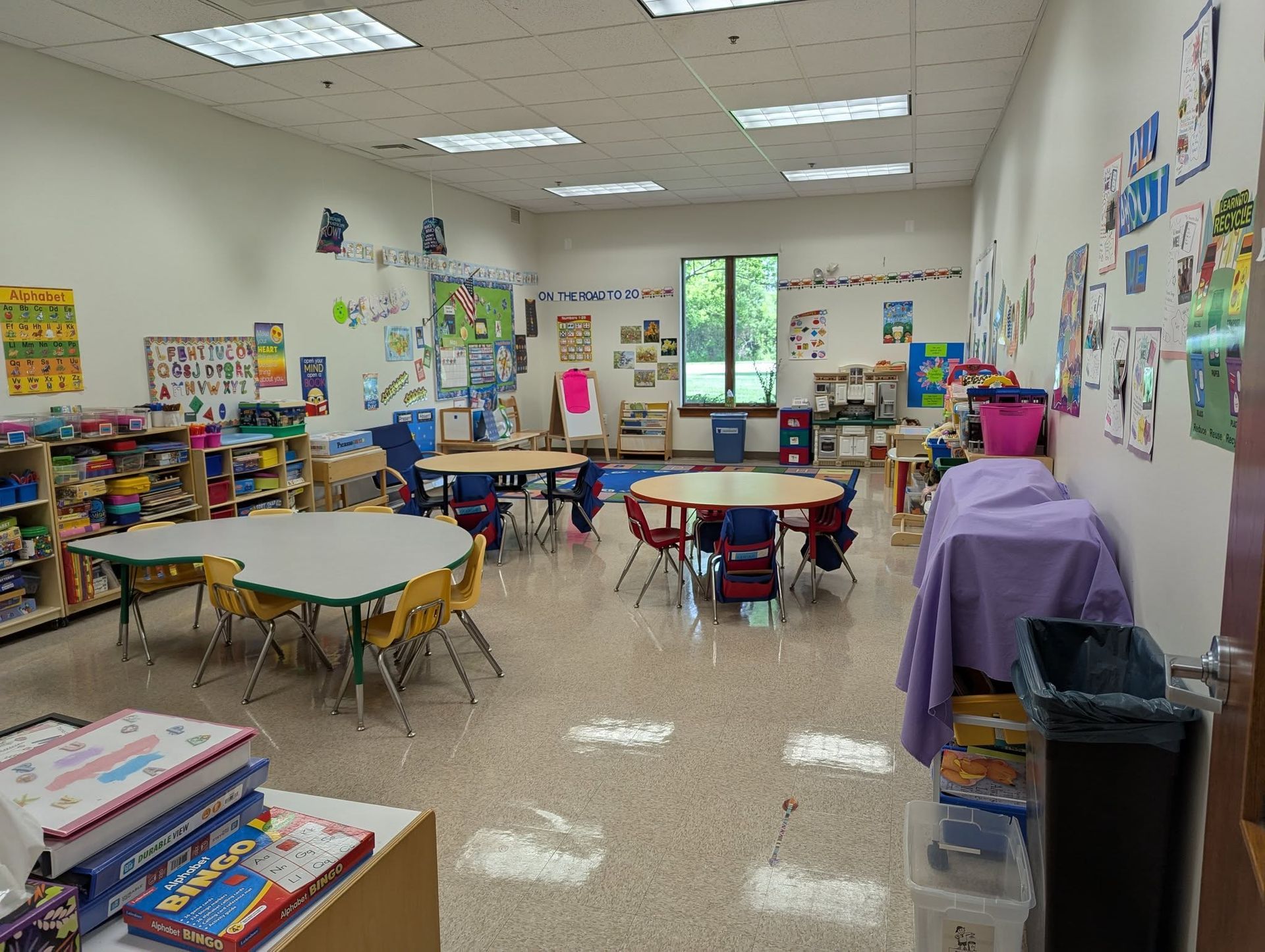 A classroom with tables and chairs.