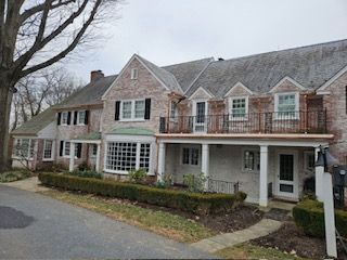 A Large Brick House With A Balcony And A Porch — Lititz, PA — Trailside Spouting, LLC