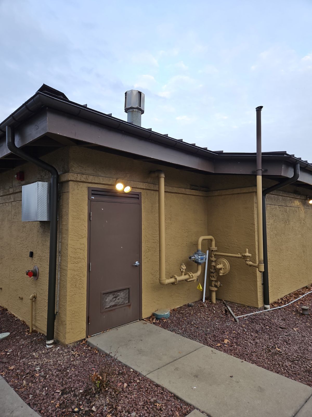 A Building with a Door and Pipes on the Side of it – Lititz, PA – Trailside Spouting, LLC