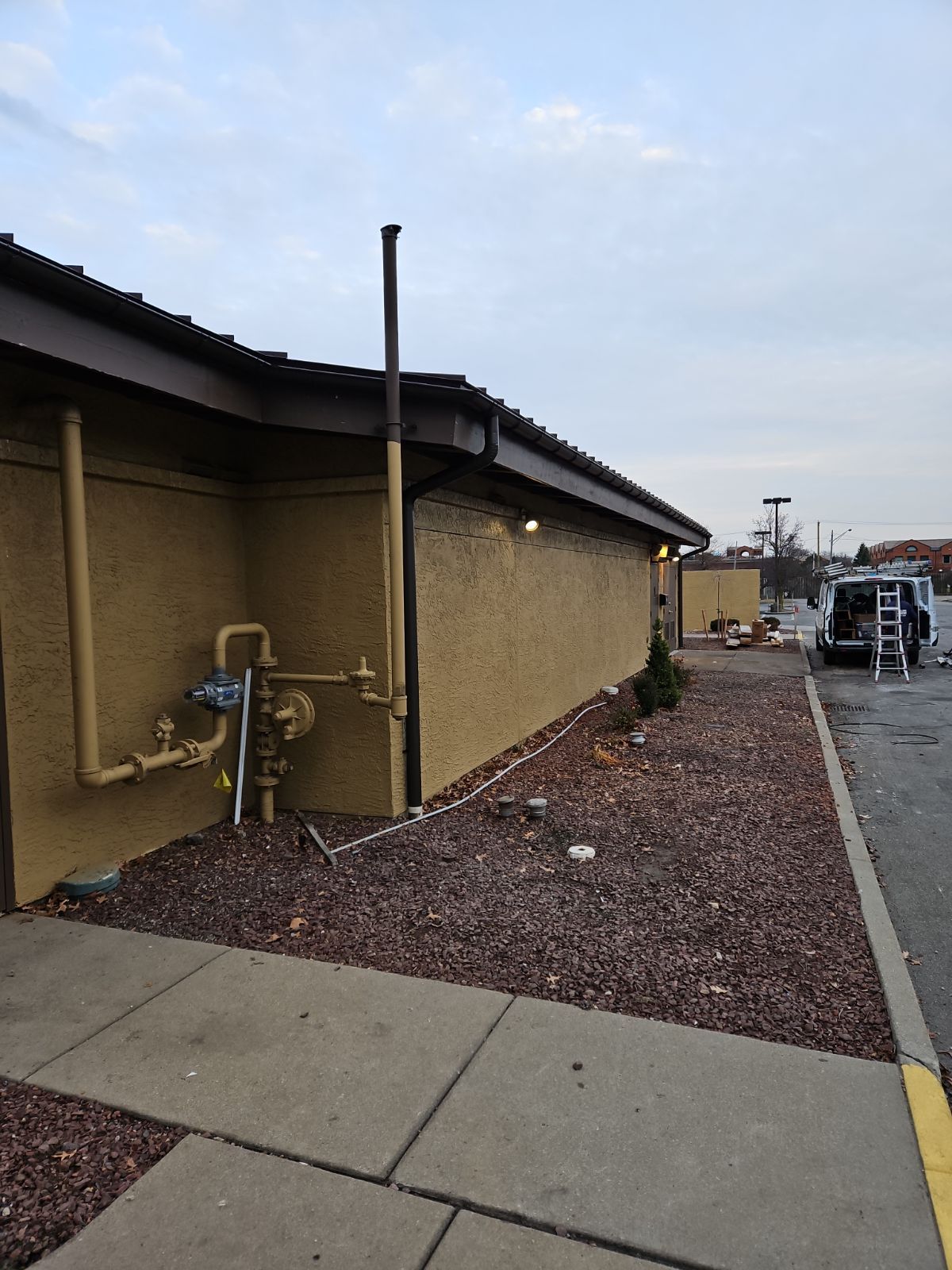 A Building with a Yellow Pipe on the Side of it – Lititz, PA – Trailside Spouting, LLC