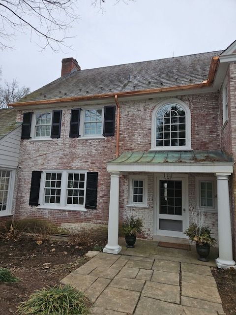 A Large Brick House With A Porch And A Copper Gutter – Lititz, PA – Trailside Spouting, LLC