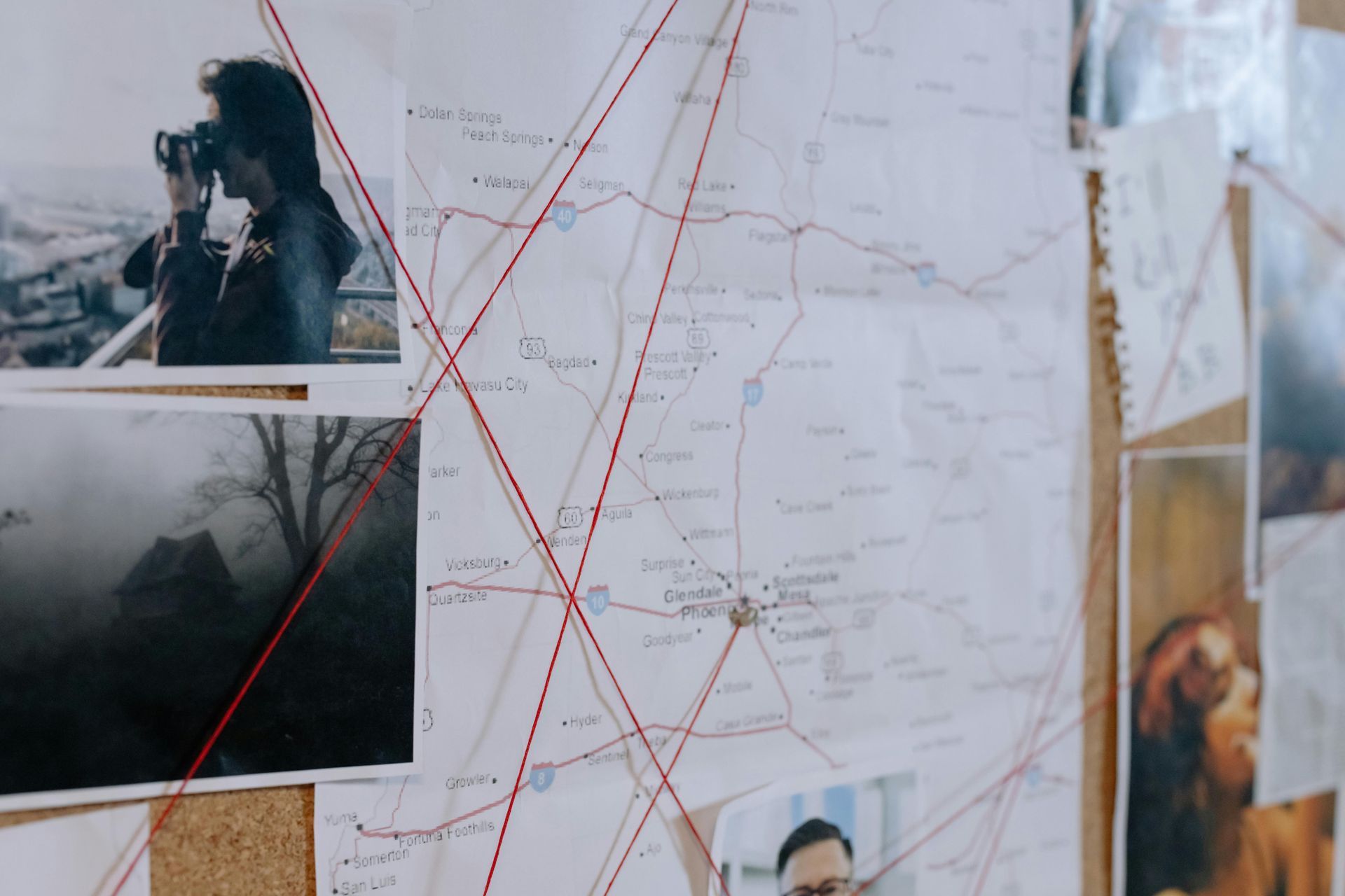 A bulletin board with pictures and a map on it.