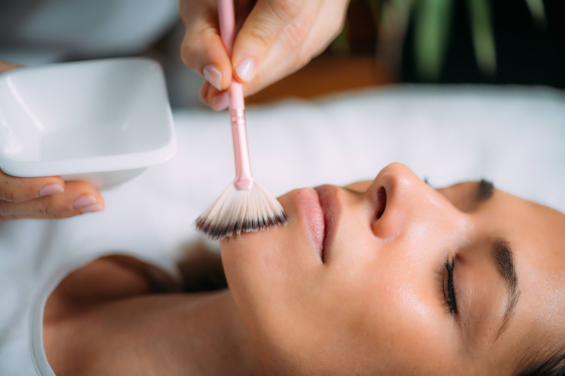 a woman is getting a facial treatment at a spa .