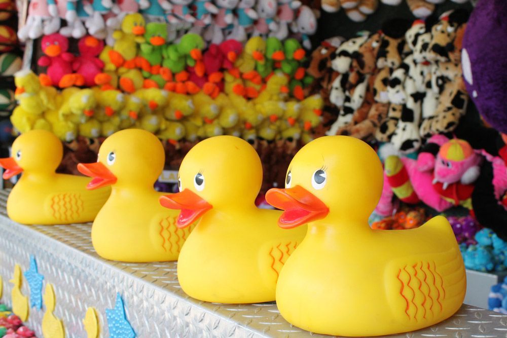 Four Yellow Toy ducks and some other Toys in Background — AMP Amusements In Rockhampton, QLD