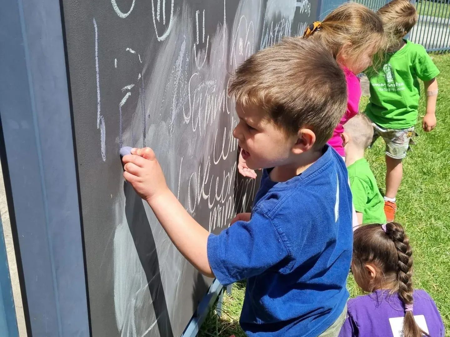 A Group Of Children Writing On A Chalkboard — Shell Heights, NSW — Junior Einsteins