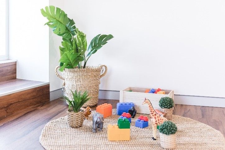 There are a lot of toys on the floor in the room.