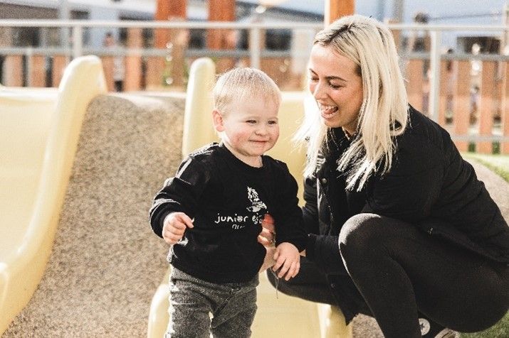 A teacher and boy playing together
