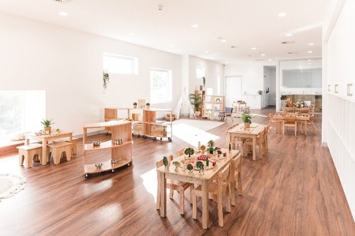 A large room with wooden tables and chairs in it.