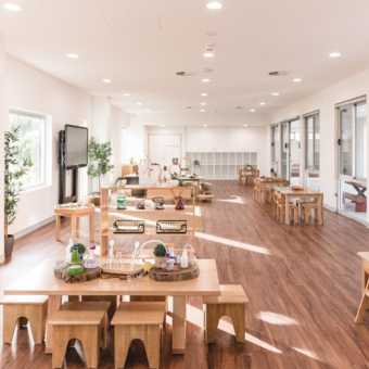 A large room with wooden tables and stools