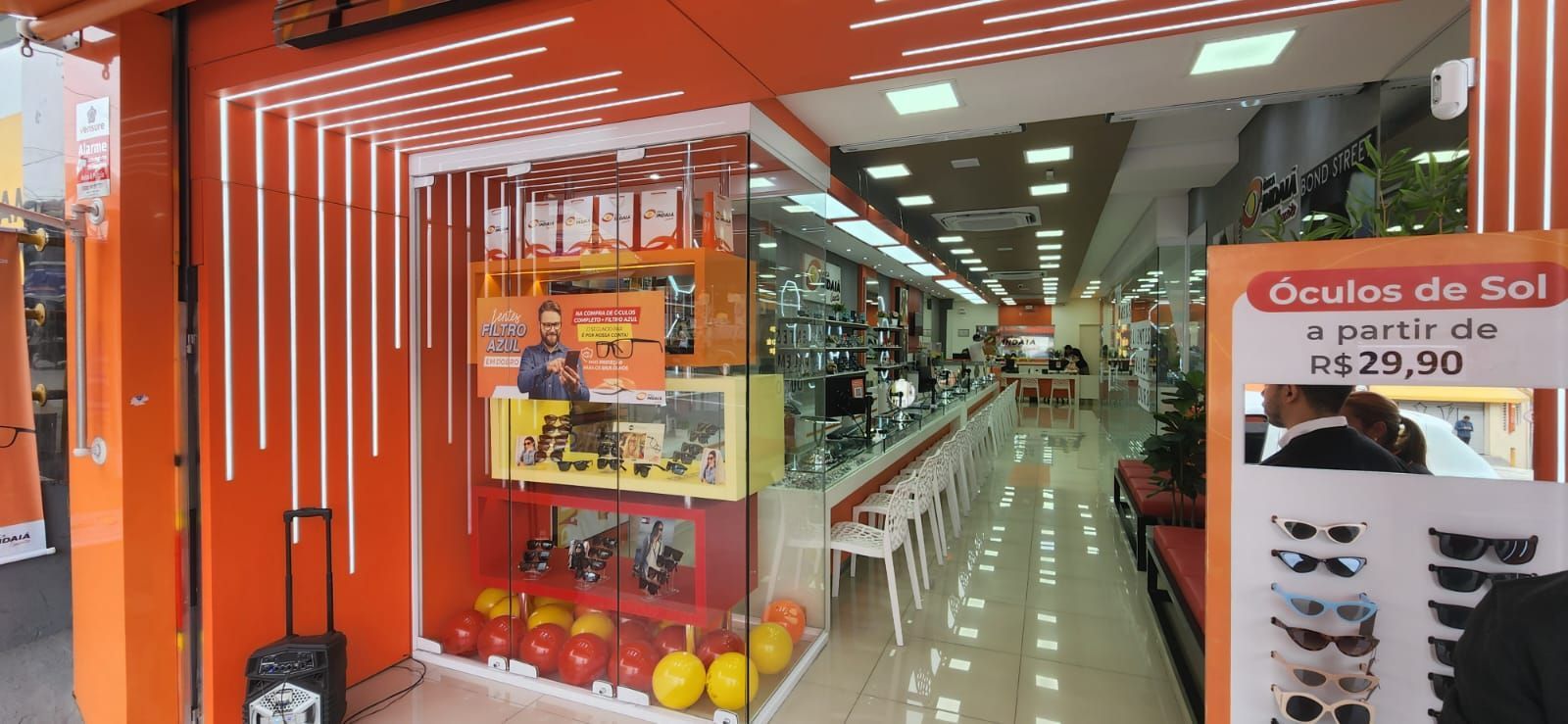 Uma fachada de loja com uma placa que diz óculos de sol