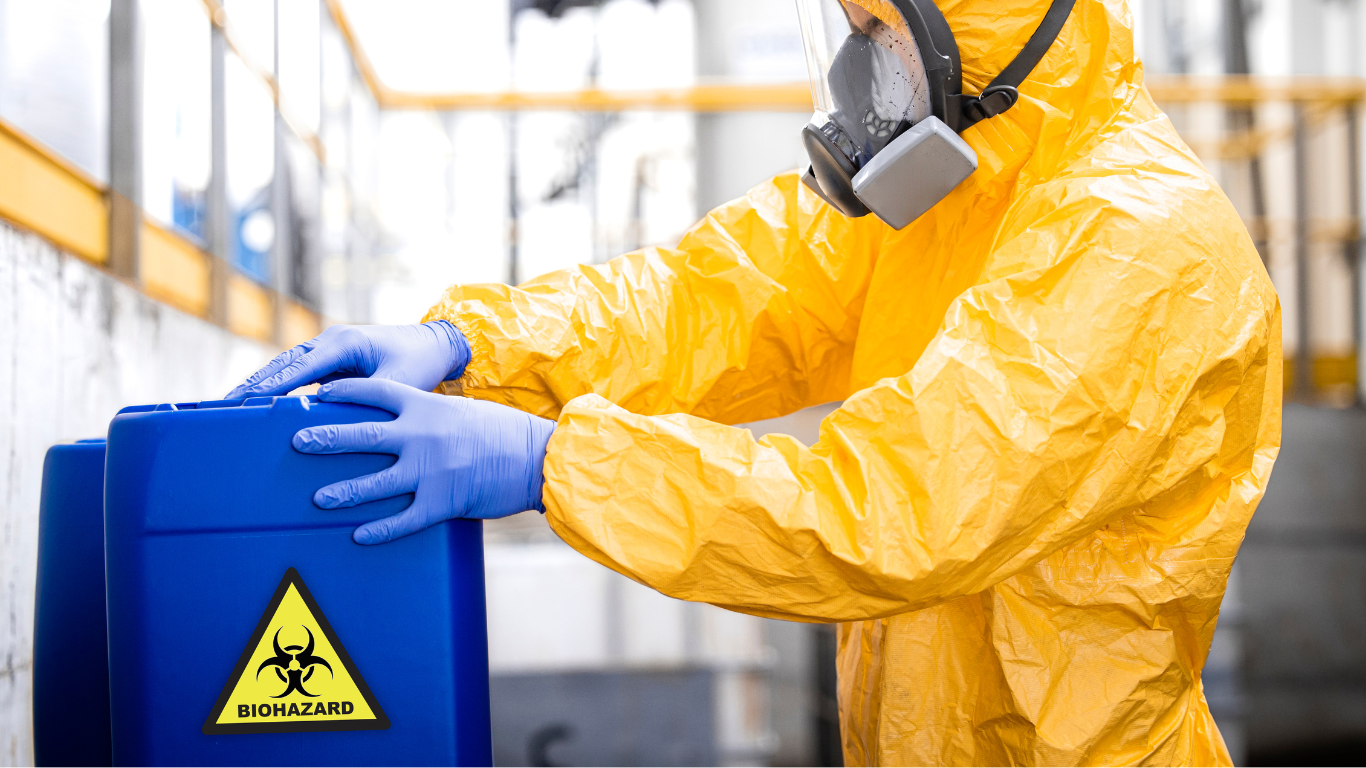 A person wearing pink gloves is working in a kitchen.