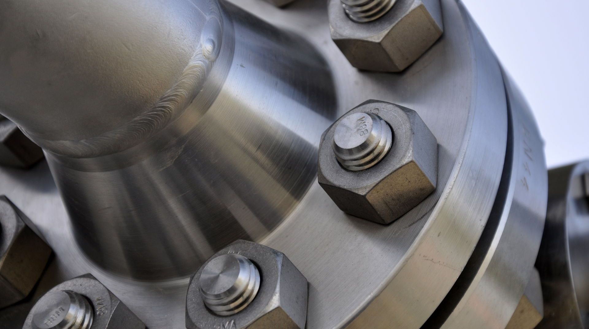 Close-up of a metal flange secured with bolts, likely part of a pipeline or industrial equipment.