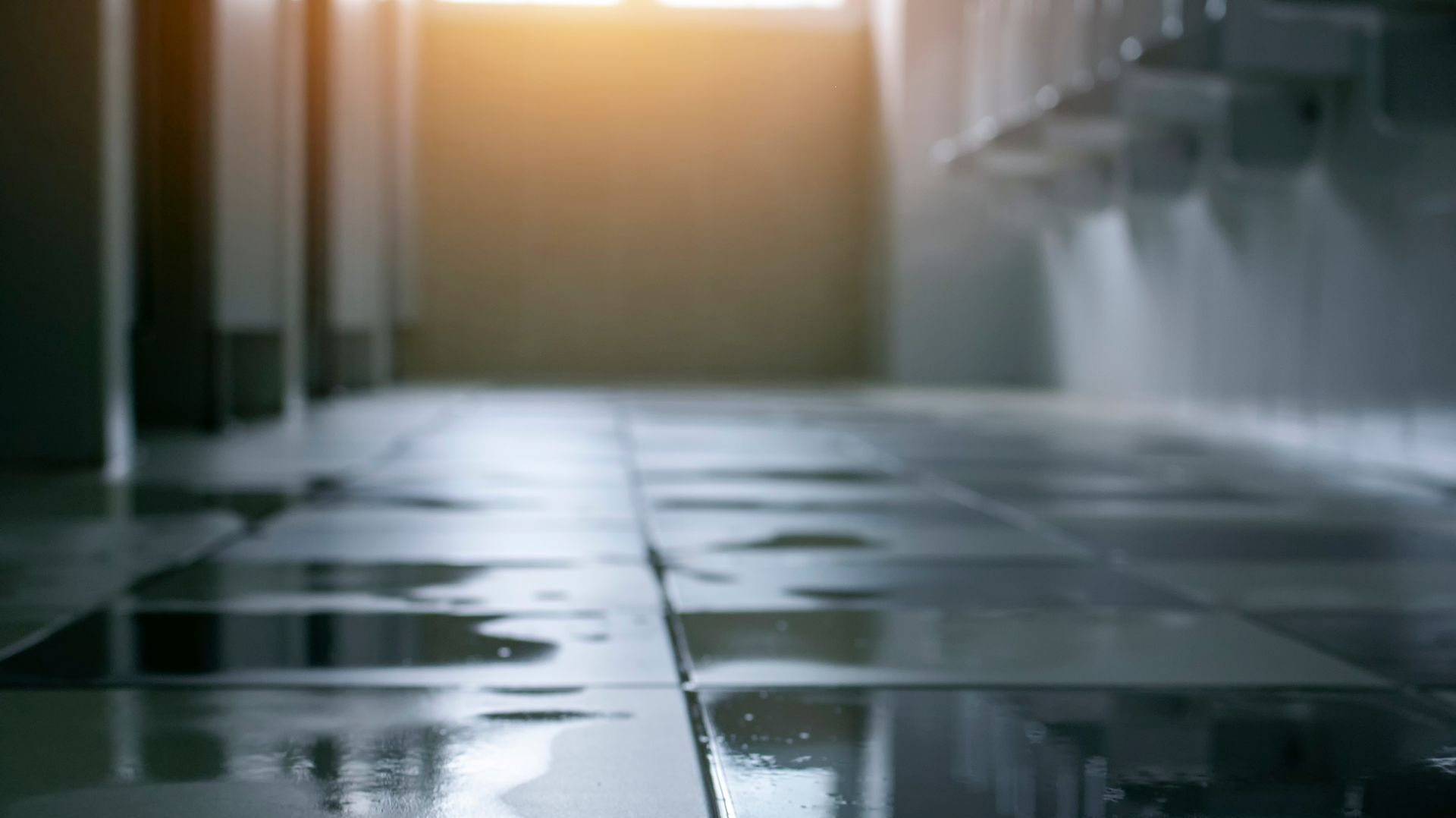 A flooded bathroom floor with a lot of water on it.