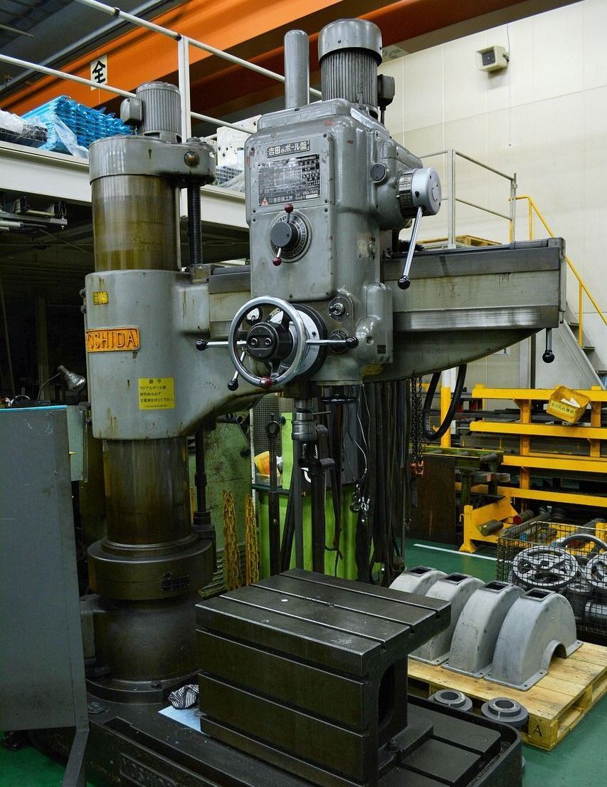 Gray industrial radial arm drill press.