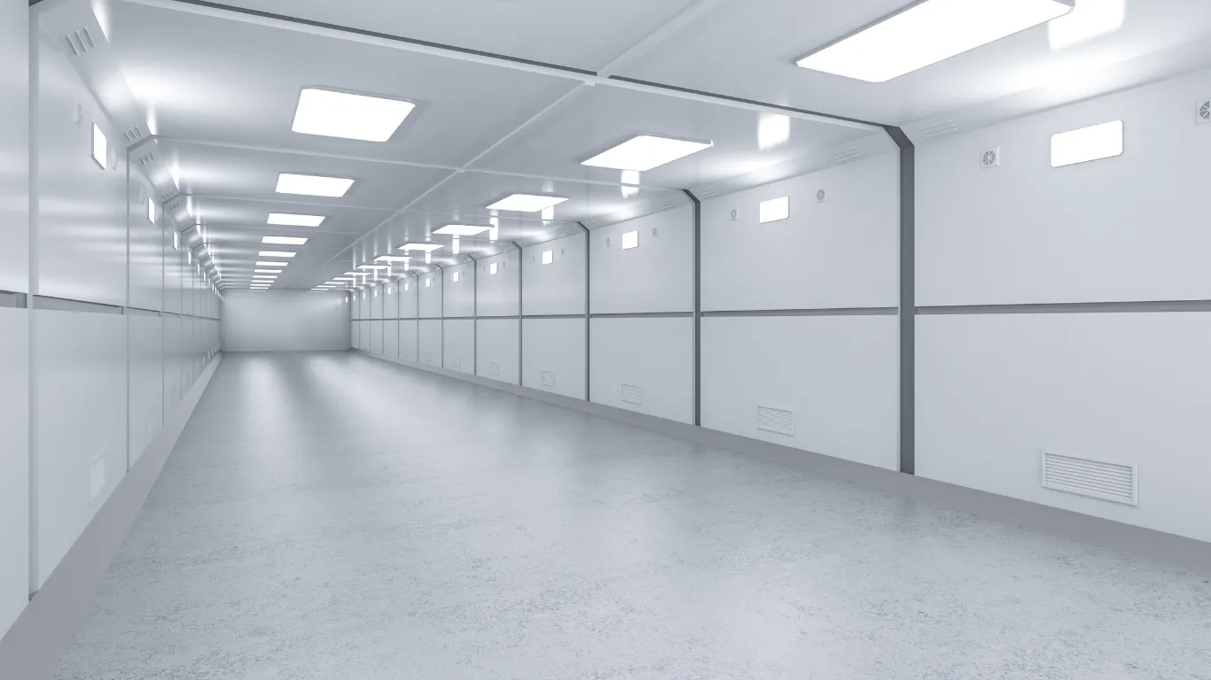 Bright, empty, white hallway with overhead lighting and smooth, reflective floor.