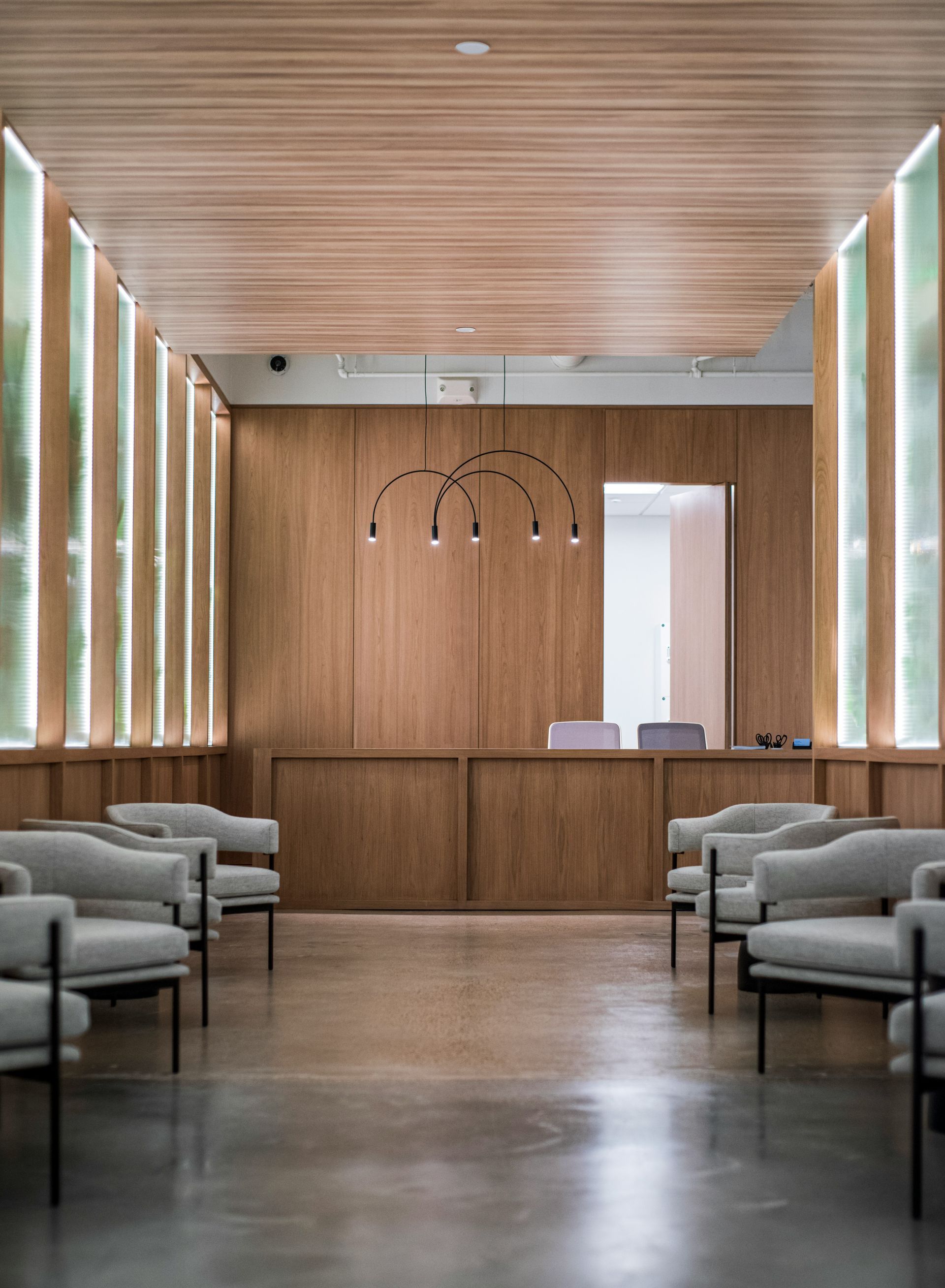 A waiting room with chairs and a wooden wall