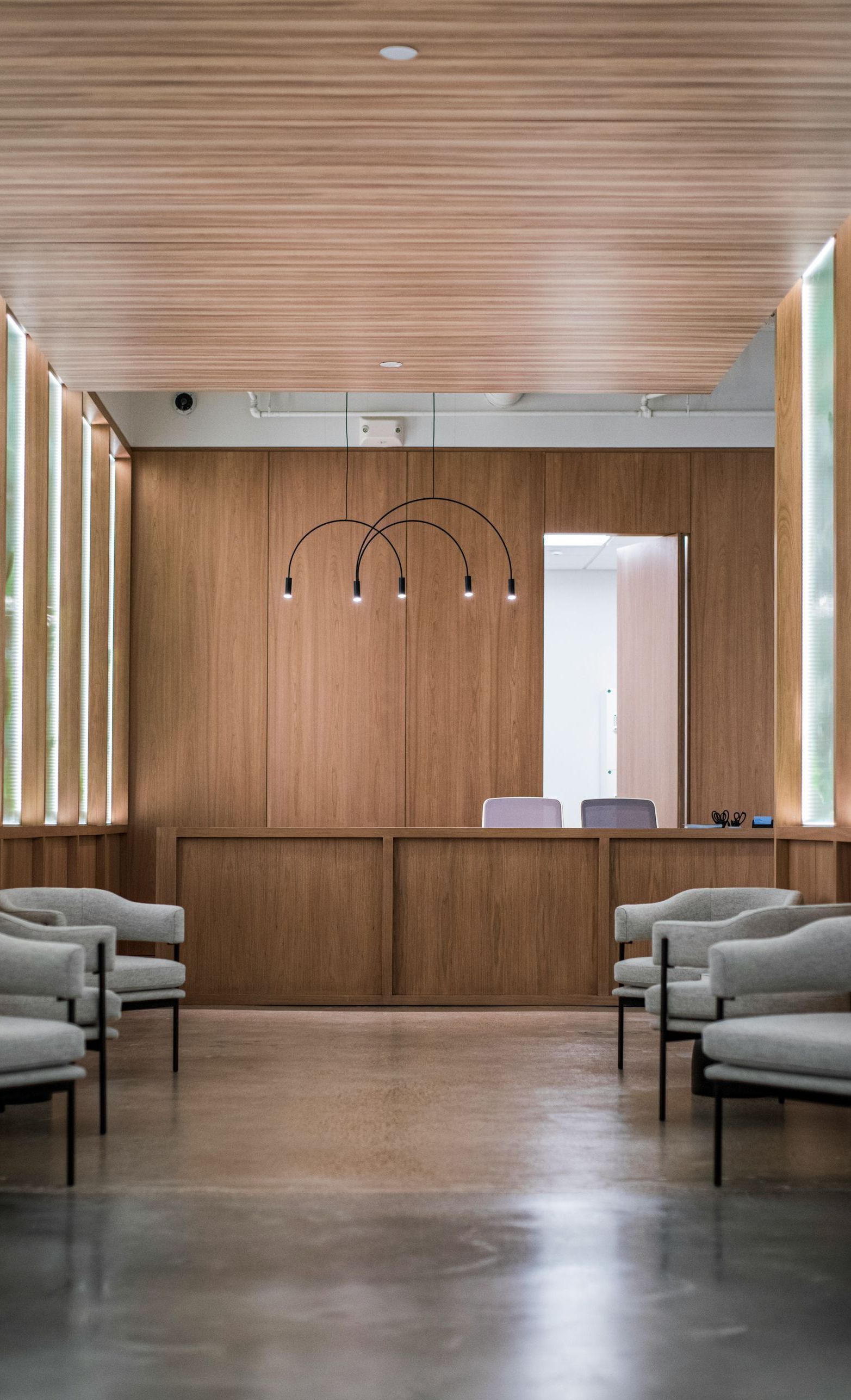 A waiting room with chairs and a wooden wall