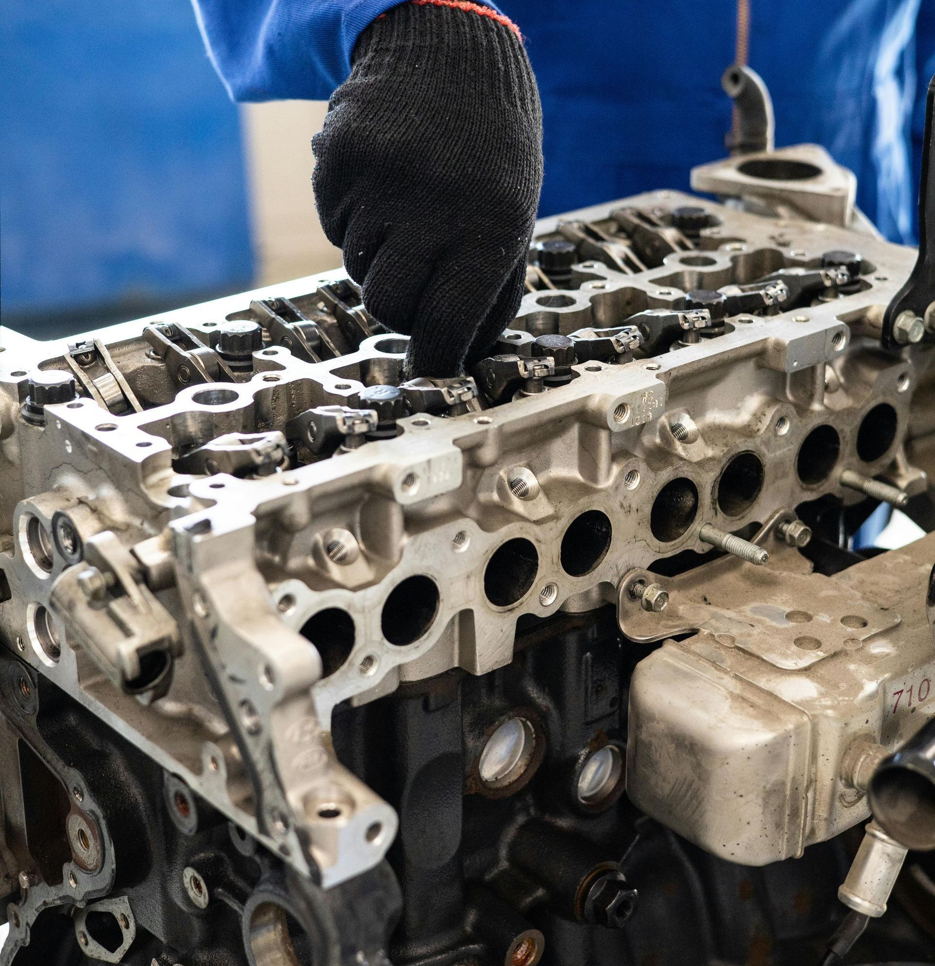 A close up of a person working on a car engine