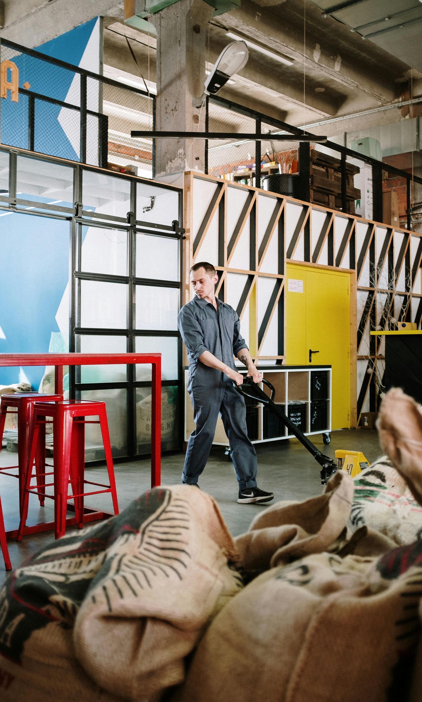 A man is cleaning a room with a vacuum cleaner.