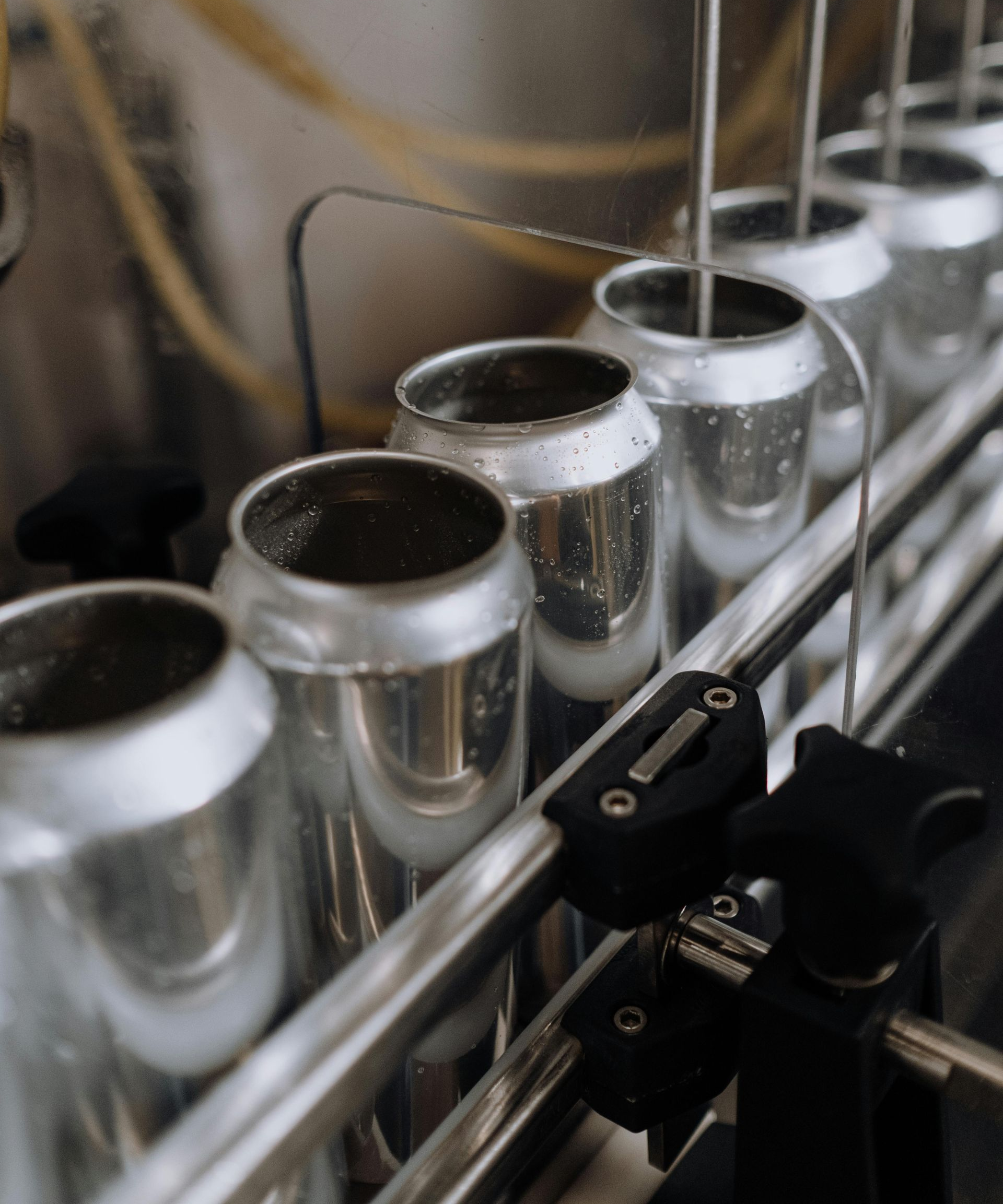 Empty aluminum cans on a factory line, ready to be filled.