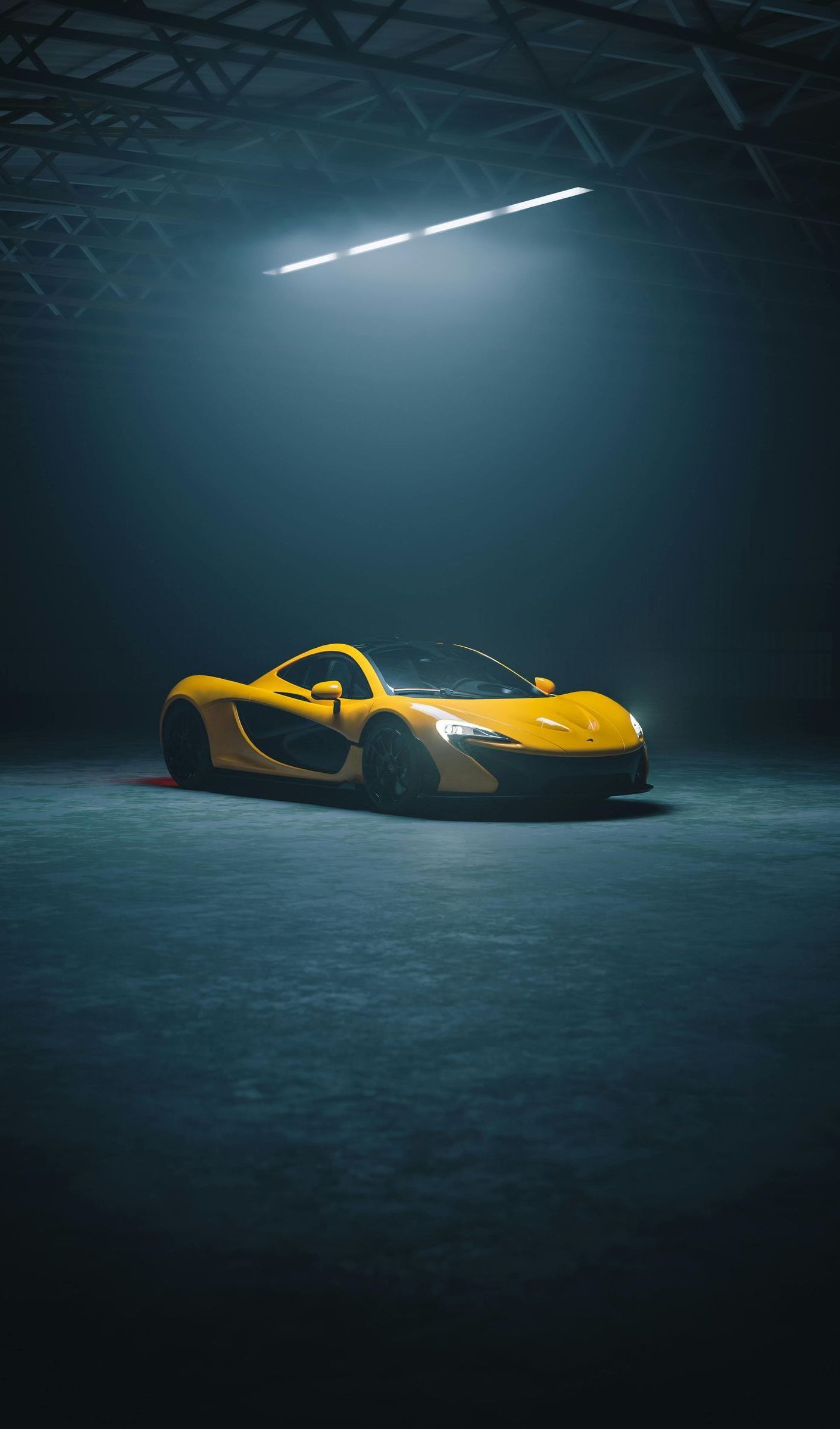 A yellow sports car is parked in a dark garage.