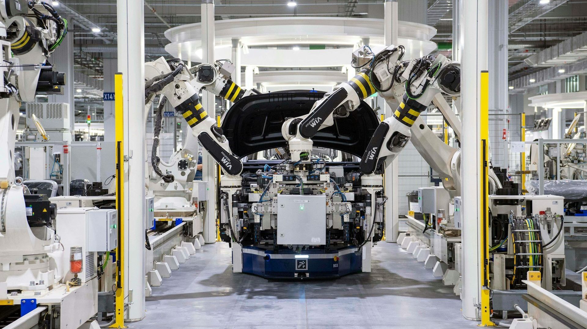 A car is being built in a factory with robots.