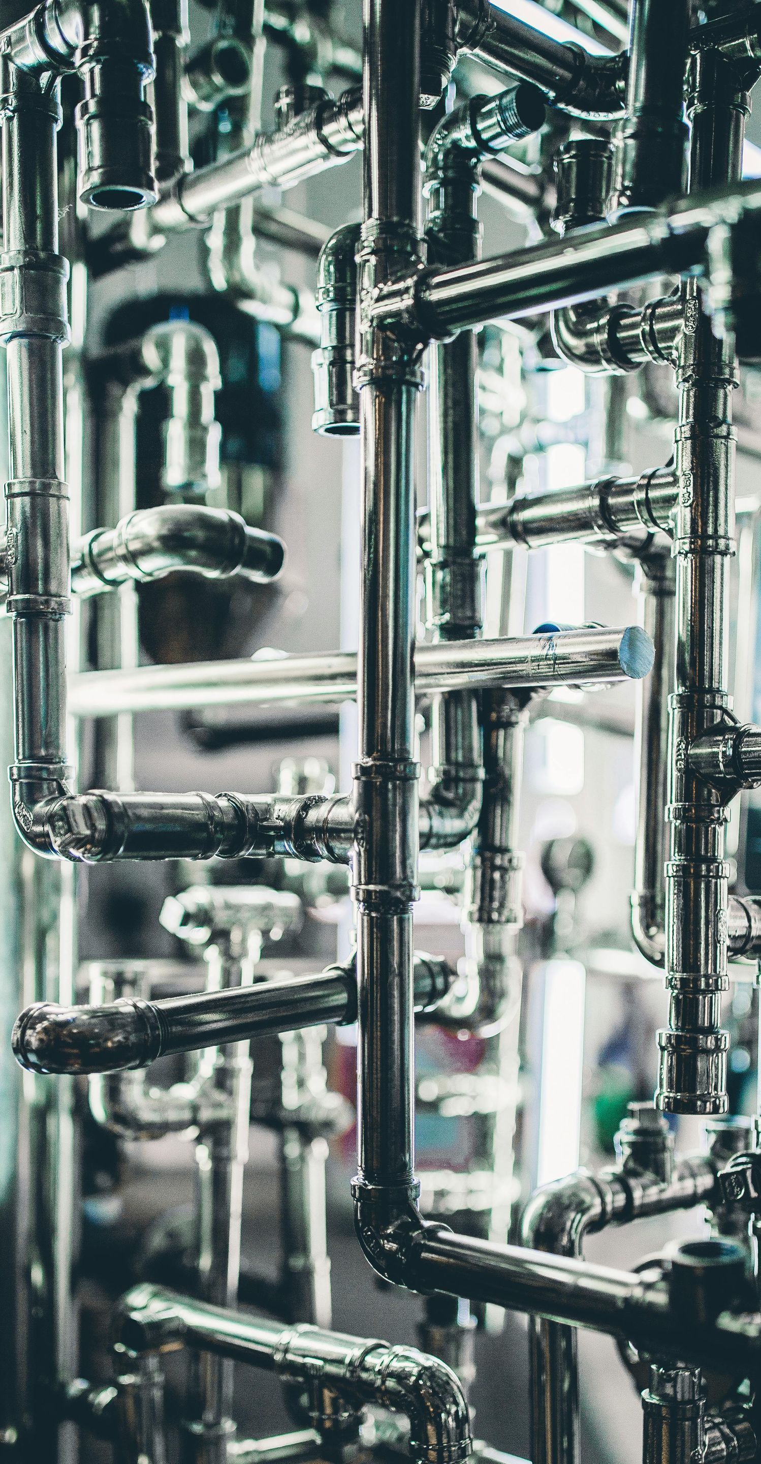 A bunch of pipes are stacked on top of each other in a factory.