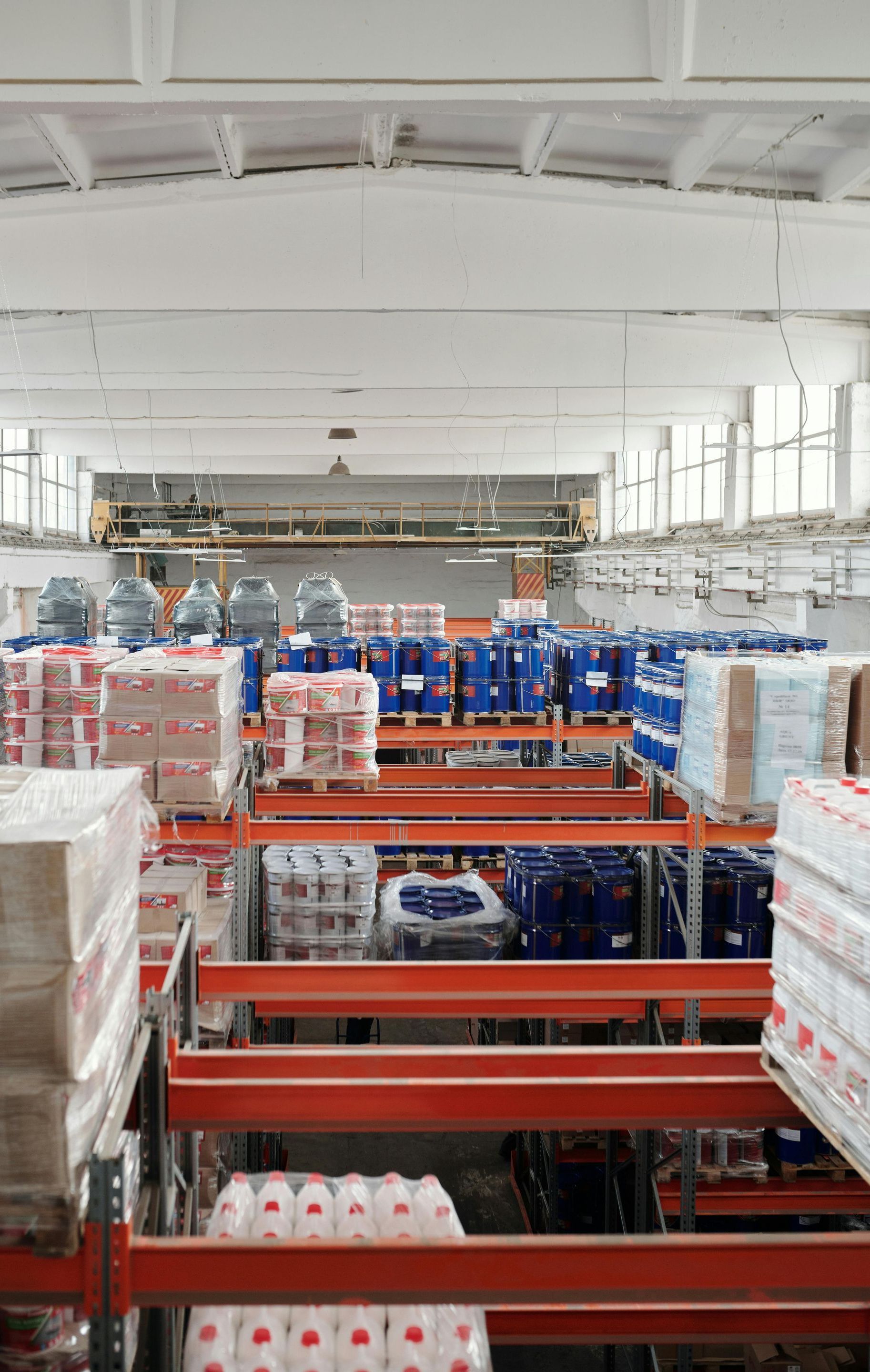 A large warehouse filled with lots of containers and boxes.