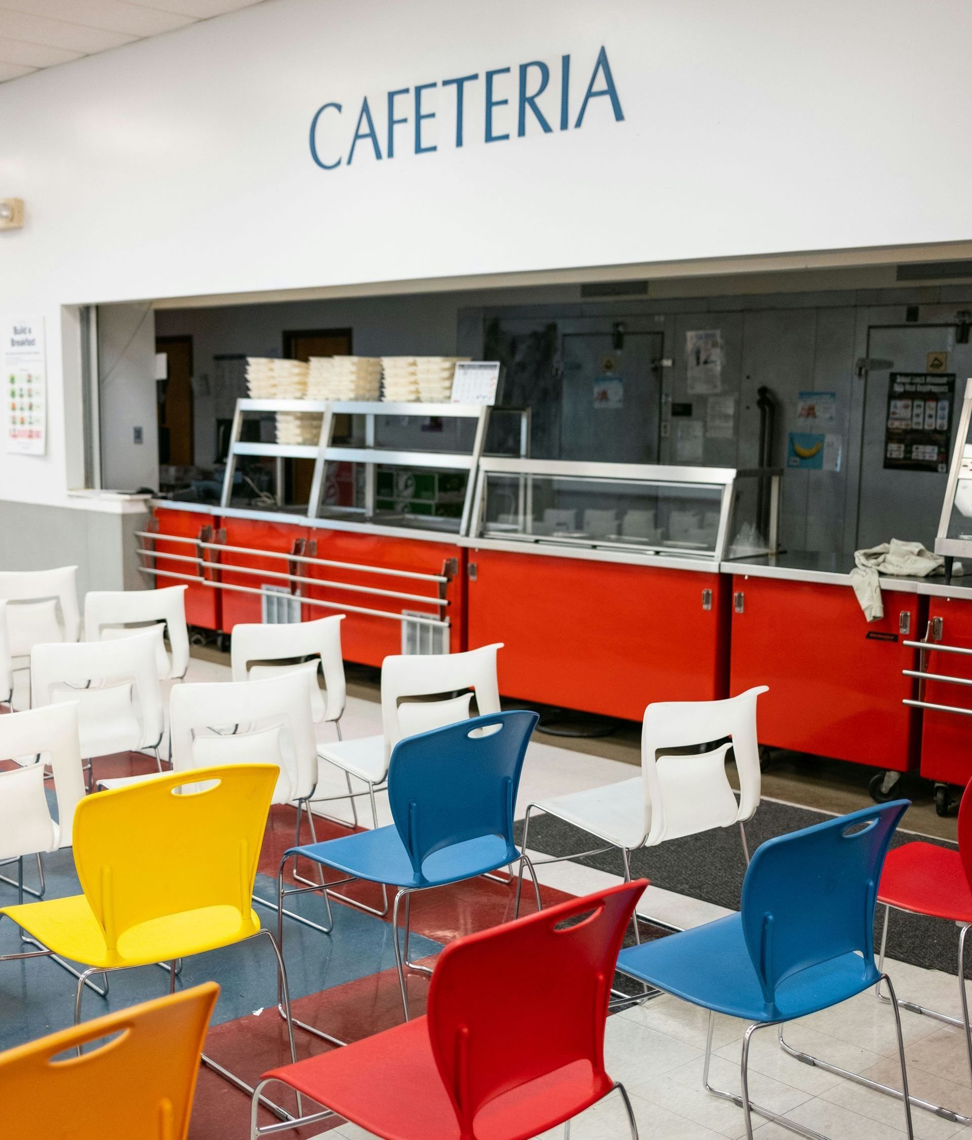 A row of chairs in front of a cafeteria