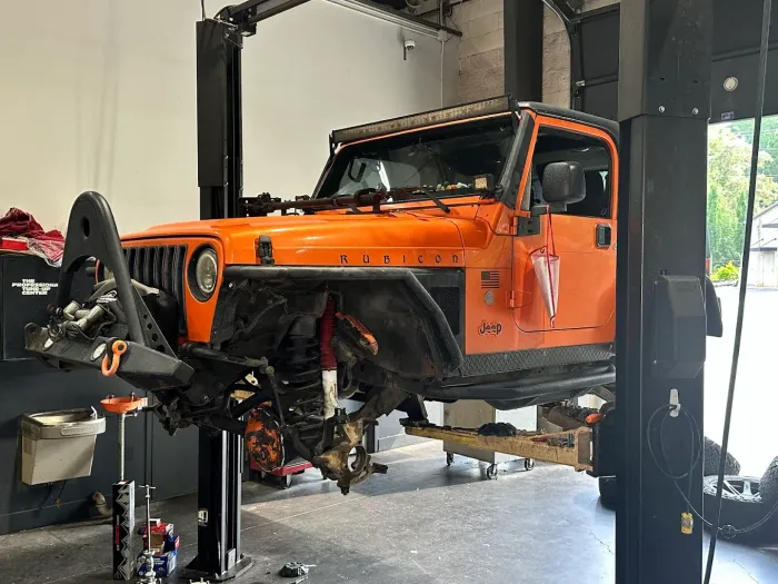 Orange Jeep Propped Up | Randy's Auto Center