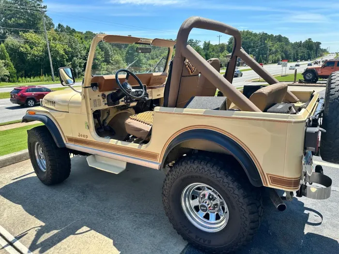 Desert Brown Jeep Parked Outside Auto Shop | Randy's Auto Center